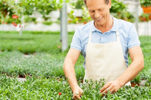 Technician wearing PPE handling garden chemicals carefully